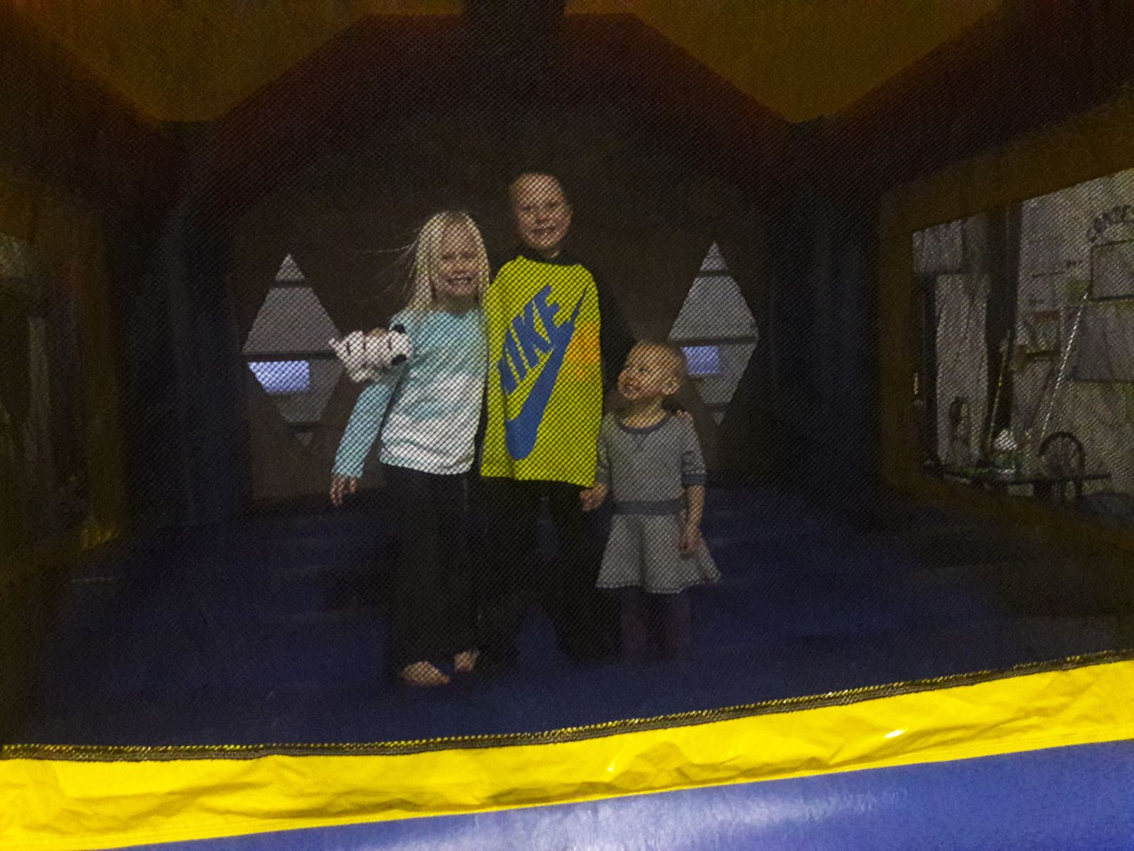 3 Kids inside Justice League Bounce House